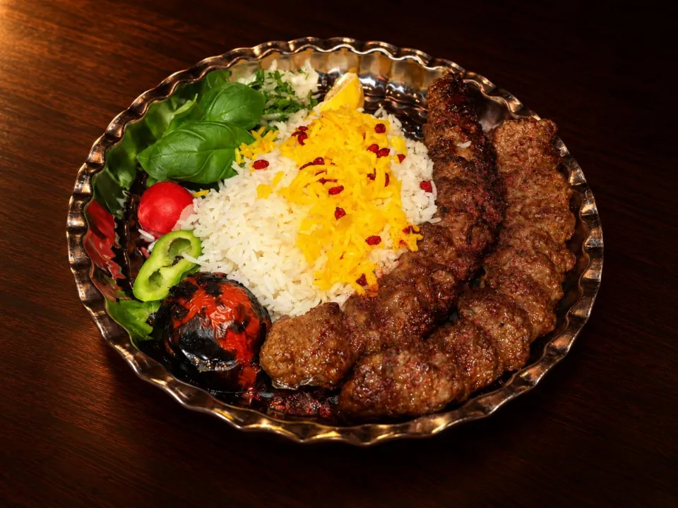 Two skewers of koobideh with rice